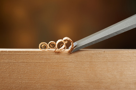 Woodworking tool. Carving wood with a chiselの写真素材