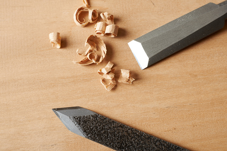 Woodworking tool. Chisel and marking knife with shavings on a workbench.の写真素材
