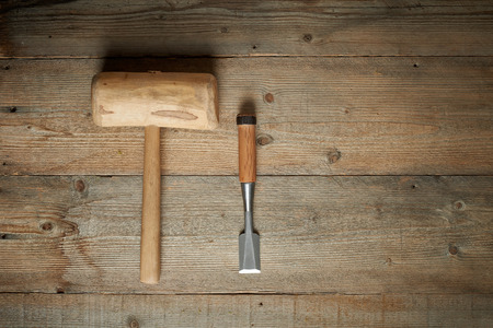 Top view, mallet and chisel on a wooden workbenchの写真素材