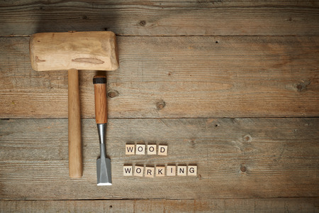 Top view, mallet and chisel on a wooden workbenchの写真素材