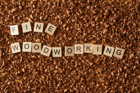 Fine woodworking word writen with letters on wood chipsの写真素材