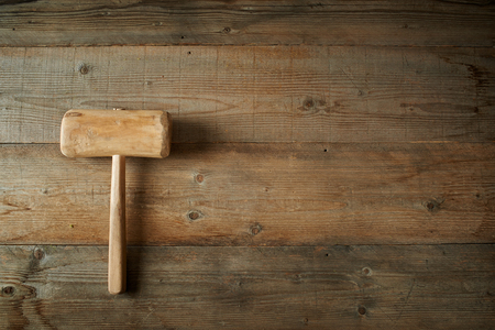 Top view, mallet on an old wooden workbenchの写真素材