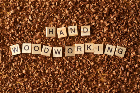 Hand woodworking word writen with letters on wood chipsの写真素材
