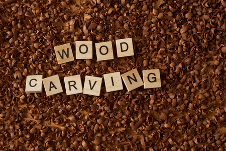 wood carving word writen with letters on wood chipsの写真素材