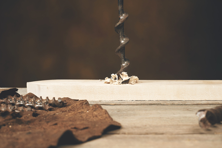 drilling wood with auger bit on workbenchの写真素材