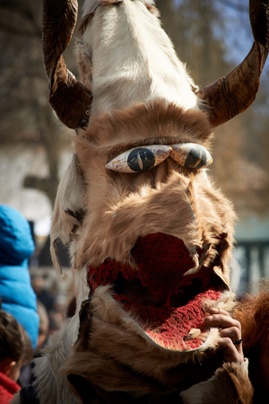 SHIROKA LAKA, BULGARIA - MARCH 5: People dressed in traditional costumes called Kukeri celebrate arrival of Spring with ritual dances in Shiroka Laka, Bulgaria, on March 5, 2017.のeditorial素材