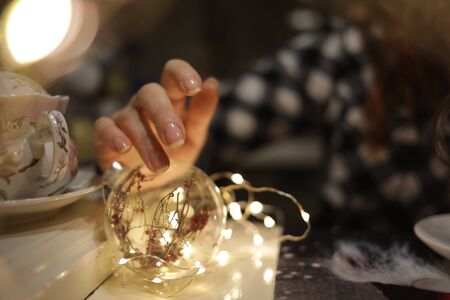 The girl holds a garland in her hand, the proximity of Christmasの写真素材