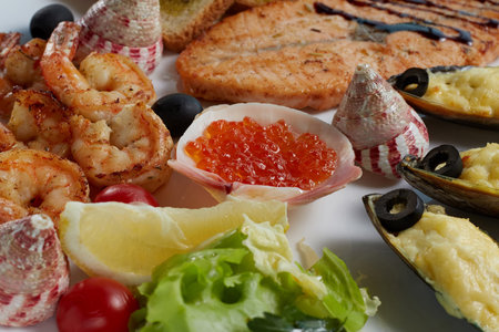 sea assorted salmon with soy sauce, caviar, mussels baked with cheese and olives, grilled shrimp,...