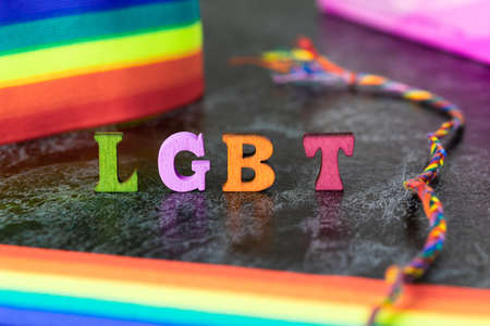 Gay pride letters LGBT rainbow ribbon on gray-black backgroundの写真素材