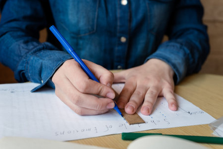 the girl hands with a blue felt pen draws a schedule of emotions using a ruler, a green felt-tip pen...
