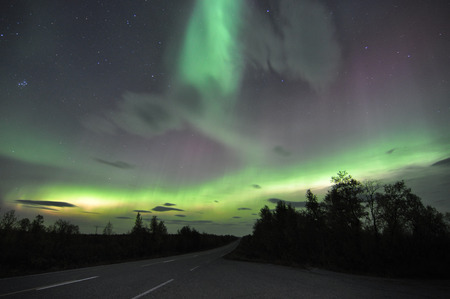 Northern lights or polar lights. An aurora is a natural light display in the sky, predominantly seen in the high latitude Arctic and Antarctic regions.の写真素材