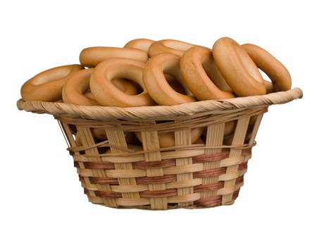 Tasty bagels in the basket isolated on white backgroundの写真素材