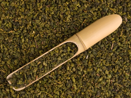 Bamboo scoop with dry green ooolong tea leavesの写真素材