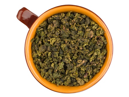 Top view of ceramic cup with dry green oolong tea leavesの写真素材