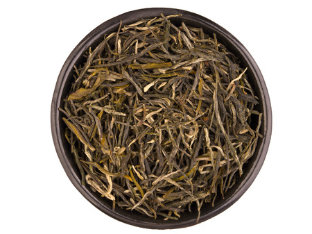 Black metal tea cup with green tea brew isolated on white backgroundの写真素材