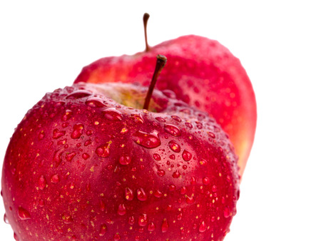 Two wet red apples with water drops isolated on white backgroundの写真素材