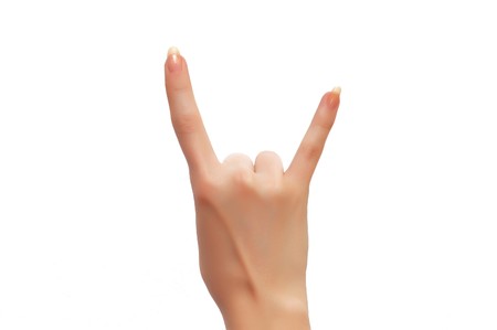 Hand formed in a goat sign isolated on whiteの写真素材