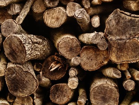 closeup of pile of chopped wood logs, for backgroundsの写真素材