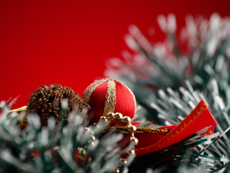 Christmas decorations over red background, closeup, for various christmas related themes and backgroundsの写真素材