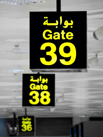 Gate signs in the airport building written in arabic languageの写真素材