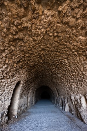 Stone tunnel with the far end in a darkness.の写真素材