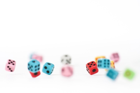 Falling dices, still in motion. The red one is in focus.の写真素材