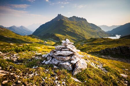 Stone cairn with Giglachsee lake behind, Austria Alpsの写真素材