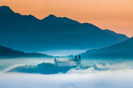 Wallfahrtskirche Frauenberg an der Enns during sunrise above clouds, Ardning, Austriaの写真素材