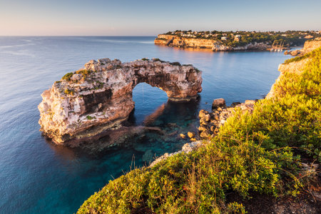 Es Pontas natural arch in Mallorca, Cala Llombards bay visible on the right
