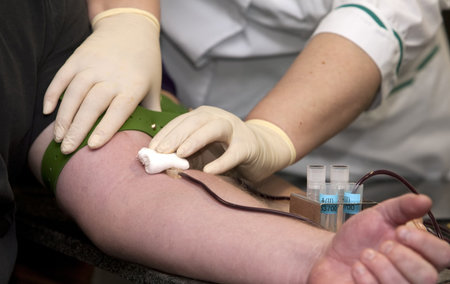 Nurse taking blood draw in hospital.