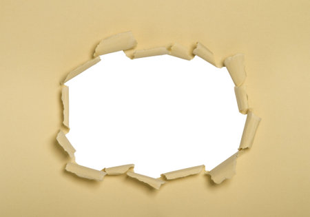 a hole punched into cream paper, white center.