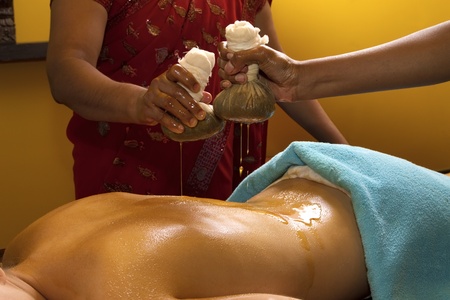   indian doctors doing traditional ayurvedic oil back massageの写真素材