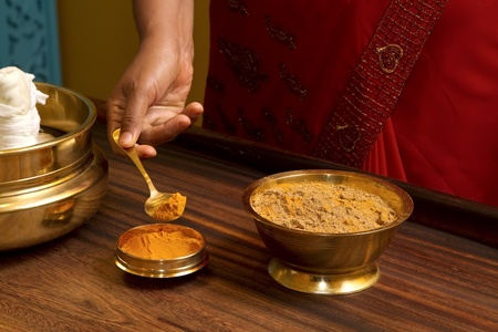  preparing herbs powder for  traditional indian ayurvedic  massage の写真素材