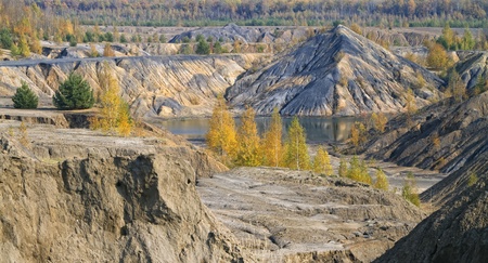 panorama of autumn forest with sand hills and lakeの写真素材