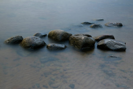 Stones in the Water at Evening Sun, Long time Exposureの写真素材