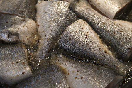 Cooking fish, deep fried fishes in hot oil in a frying panの写真素材