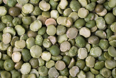A background of split dry green peas, close up view.