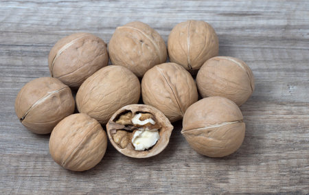 Set of delicious walnuts on wooden background.