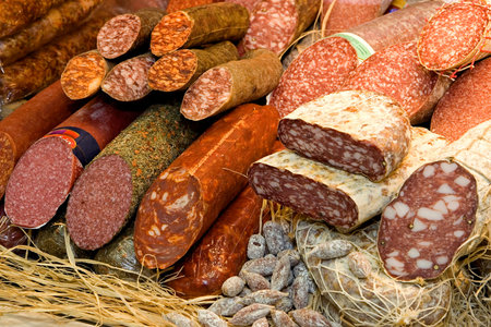 Different types of raw smoked sausage on the store shelf.
