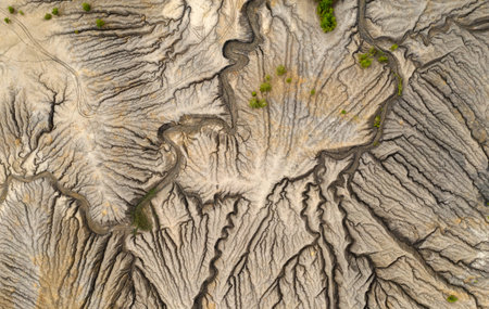 Aerial view of abandoned quarry with canyons and cracks.