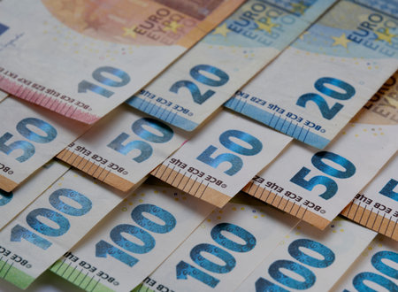 Euro banknotes and coins. Euro money. Background of bills and coin of European union currency. Close...