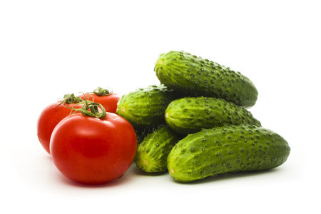 cucumbers and tomatoes isolated on whiteの写真素材