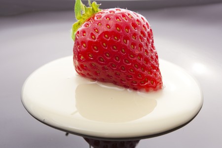 red strawberry on black plate close-upの写真素材