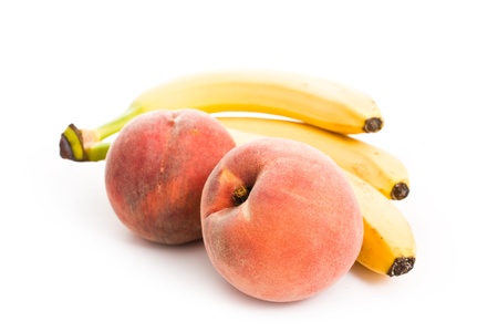 peaches and bananas isolated on white - vegeterian healthy foodの写真素材