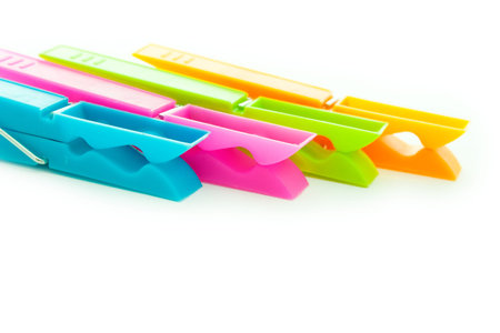 close up shot of multicolored clothespins isolated on white 