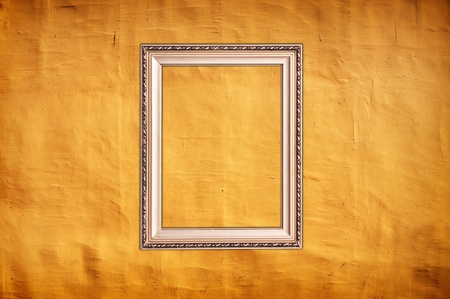 close up shot of vintage yellow wall as background with artistic shadows addedの写真素材