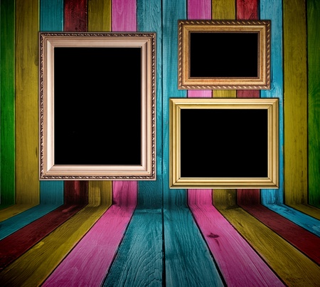 vintage multicolored wooden wall with blank framesの写真素材