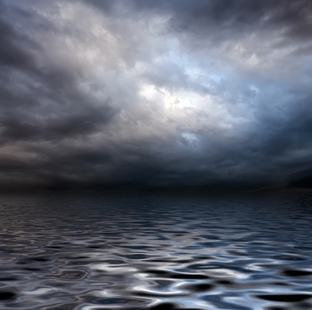 dark storm sky over water surface with artistick shadows addedの写真素材
