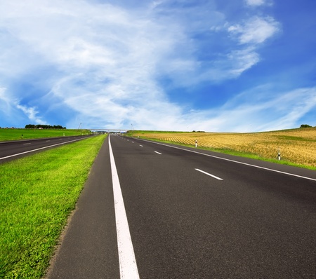 asphalt road over blue sky - travel concept の写真素材