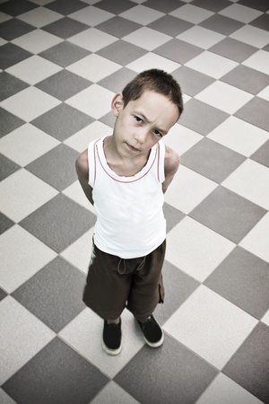 sad boy standing alone over black and white backgroundの写真素材